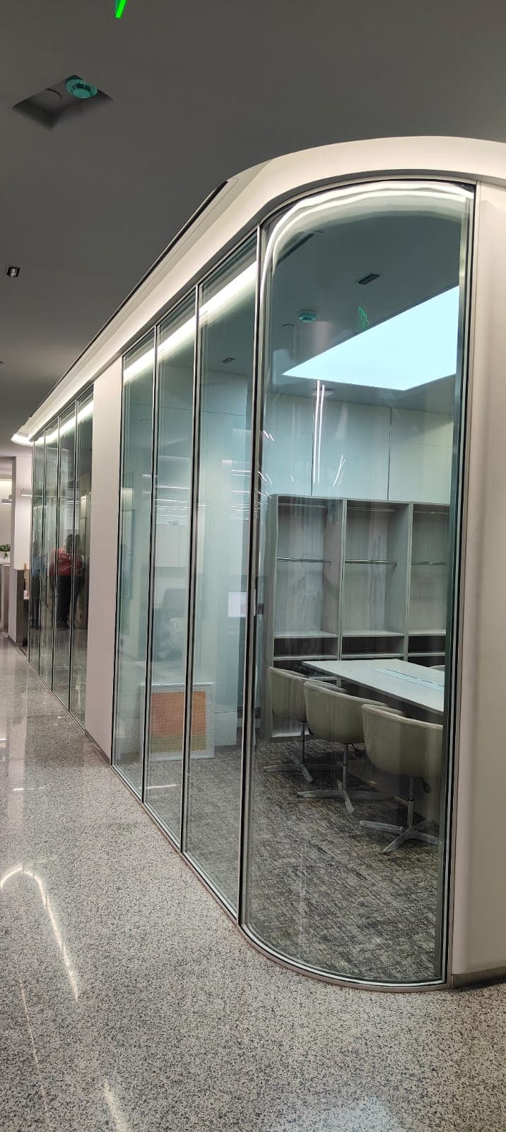 Curved glass partition system by Cube Partitions